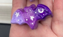 Load image into Gallery viewer, Cute and spooky magnet design to adorn your refrigerator, lockers, workstation, toolbox, or dishwasher. This hand-sculpted clay bat statuette boasts stunning ombre coloration, transitioning from dark purple to light purple to recreate the breathtaking look of a starry night sky. H 1” x W 2” x D 1/2”