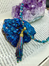 Load image into Gallery viewer, This necklace boasts a stunning Rainbow Kyanite wired stone pendant and two strands of shimmering glass beads. The blues contain hues of pink, gold, blue and green, offering a vibrant and bold addition to any jewelry collection. Measurements: Necklace is 17” in length, can be adjusted to 18"