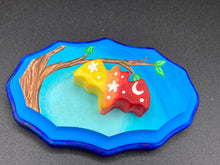 Load image into Gallery viewer, This unique Starry Night Mini Bat Wall Art Decor is hand sculpted and painted in vivid hues to offer an eye-catching decoration for your living space. The bat is painted in a gradient of yellow, to orange, to dark red, and is complemented by white stars and a crescent moon. The wood frame is painted in light to dark blues for a stunning night effect for a drastic contrast to the warm tone bat.