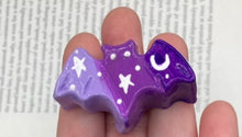 Load image into Gallery viewer, Cute and spooky magnet design to adorn your refrigerator, lockers, workstation, toolbox, or dishwasher. This hand-sculpted clay bat statuette boasts stunning ombre coloration, transitioning from dark purple to light purple to recreate the breathtaking look of a starry night sky. H 1” x W 2” x D 1/2”