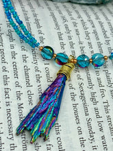 Load image into Gallery viewer, This Rainbow Kyanite Natural Wired Stone Choker Style Necklace presents two strands of light blue glass beads, and is adorned with a Kyanite stone known for its shimmering array of pink, gold, blue, and green hues. Providing a bold and attention-grabbing look, this piece of Hippie Crystal Jewelry is a must-have addition to any wardrobe. Necklace is 17 1/2” in length