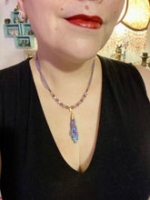 Load image into Gallery viewer, This Rainbow Kyanite Wired Stone Pendant features two strands of glass bead necklaces with a dazzling spectrum of colors, including purple, pink, gold, blue, and green. This bold piece of jewelry is guaranteed to add an eye-catching touch to any collection. Measurements: Necklace is 17” in length, can be adjusted to 18"