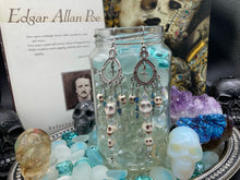 Load image into Gallery viewer, Day of The Dead, La Catrina Dia De Los Muertos Aretes, Pastel Goth Jewelry, Dangling Skulls Silver Cross Beaded Chandelier Style Earrings
