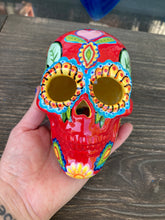 Load image into Gallery viewer, This uniquely handpainted ceramic skull is inspired by the beauty of Sedona, AZ. Features bold fire red color with nature-inspired design for a truly one-of-a-kind mini calavera. Perfect for adding a southwestern touch to your Dia de Los Muertos ofrenda. Measurements: H 4” x W 4” x D 5 1/2”