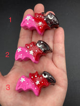 Load image into Gallery viewer, Cute and spooky magnet design to adorn your refrigerator, lockers, workstation, toolbox, or dishwasher. This hand-sculpted clay bat statuette boasts stunning ombre coloration, transitioning from black to dark red to pink to recreate the breathtaking look of a starry night sky. H 1” x W 2” x D 1/2”