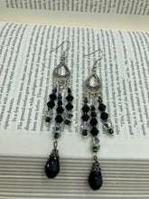 Load image into Gallery viewer, This stylish three-strand black and silver glass beaded earring design presents a beautiful dancing effect, boasting a large black teardrop glass bead. A versatile accessory, it suits a variety of ensembles from cocktail chic to wedding fineries, and its minimalist aesthetic lends a modern charm.  Measurements: 3 3/4” in length