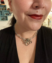 Load image into Gallery viewer, This stylish necklace features a silver plated metal octopus pendant and vibrant iridescent and silver-gray glass beads of various sizes. The Steampunk-inspired design provides a textured, patterned and voluminous look perfect for any dark goth or witchy aesthetic. Measurements: Necklace measures 15 1/2” adjustable up to 17” in length