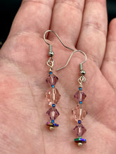 Load image into Gallery viewer, These dainty glass beaded earrings in soft pink and purple, featuring rainbow hematite beads, are perfect for summer ensembles and boho chic looks. An ideal accessory for nature lovers, these earrings will enhance any style.  Measurements: 1 1/2” in length