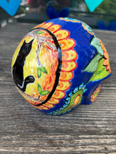 Load image into Gallery viewer, I wanted to create a Dia De Los Muertos skull that represented the eternal love for a special kitty cat in your life. Black cat silhouette is sitting admiring the sun going down. This Day Of The Dead ceramic skull art was created for the cat lovers who adore their sweet kitty. Measurements: H 4” x W 4” x D 5 1/2”