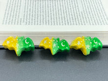 Load image into Gallery viewer, Cute and spooky magnet design to adorn your refrigerator, lockers, workstation, toolbox, or dishwasher. This hand-sculpted clay bat statuette boasts stunning ombre coloration, transitioning from to dark green to light green and then to bright yellow to recreate the breathtaking look of a starry night sky. H 1” x W 2” x D 1/2”