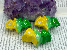 Load image into Gallery viewer, Cute and spooky magnet design to adorn your refrigerator, lockers, workstation, toolbox, or dishwasher. This hand-sculpted clay bat statuette boasts stunning ombre coloration, transitioning from to dark green to light green and then to bright yellow to recreate the breathtaking look of a starry night sky. H 1” x W 2” x D 1/2”