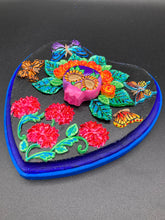 Load image into Gallery viewer, Frida Kahlo inspired calavera with a dark wood frame, this Day of the Dead wall decor piece is perfect for adding a traditional Mexican folk art touch to any home. Featuring an intricately detailed clay calavera in the style of Frida Kahlo, this Day of the Dead wall art decor is sure to be the centerpiece of any home décor. The calavera is wearing Frida's iconic crown of flowers and with several butterflies around her, ensuring it will bring both a unique and inspiring look to any wall.