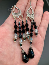 Load image into Gallery viewer, This stylish three-strand black and silver glass beaded earring design presents a beautiful dancing effect, boasting a large black teardrop glass bead. A versatile accessory, it suits a variety of ensembles from cocktail chic to wedding fineries, and its minimalist aesthetic lends a modern charm.  Measurements: 3 3/4” in length