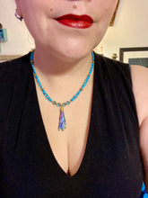 Load image into Gallery viewer, This Rainbow Kyanite Natural Wired Stone Choker Style Necklace presents two strands of light blue glass beads, and is adorned with a Kyanite stone known for its shimmering array of pink, gold, blue, and green hues. Providing a bold and attention-grabbing look, this piece of Hippie Crystal Jewelry is a must-have addition to any wardrobe. Necklace is 17 1/2” in length