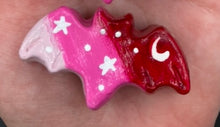 Load image into Gallery viewer, Cute and spooky magnet design to adorn your refrigerator, lockers, workstation, toolbox, or dishwasher. This hand-sculpted clay bat statuette boasts stunning ombre coloration, transitioning from dark red to light pink to recreate the breathtaking look of a starry night sky. H 1” x W 2” x D 1/2”