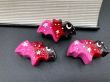 Load image into Gallery viewer, Cute and spooky magnet design to adorn your refrigerator, lockers, workstation, toolbox, or dishwasher. This hand-sculpted clay bat statuette boasts stunning ombre coloration, transitioning from black to dark red to pink to recreate the breathtaking look of a starry night sky. H 1” x W 2” x D 1/2”