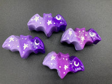 Load image into Gallery viewer, Cute and spooky magnet design to adorn your refrigerator, lockers, workstation, toolbox, or dishwasher. This hand-sculpted clay bat statuette boasts stunning ombre coloration, transitioning from dark purple to light purple to recreate the breathtaking look of a starry night sky. H 1” x W 2” x D 1/2”