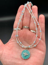 Load image into Gallery viewer, Make a statement with this dainty, yet bold Amazonite Bee Pendant Necklace. Beautifully beaded with frosty glass in blue and silver tones, this shabby chic jewelry piece complements any outfit. The perfect combination of hues and shapes will add complexity and elegance to your look. Measurements: Necklace is 17” in length