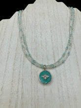 Load image into Gallery viewer, Make a statement with this dainty, yet bold Amazonite Bee Pendant Necklace. Beautifully beaded with frosty glass in blue and silver tones, this shabby chic jewelry piece complements any outfit. The perfect combination of hues and shapes will add complexity and elegance to your look. Measurements: Necklace is 17” in length