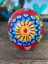 Load image into Gallery viewer, This uniquely handpainted ceramic skull is inspired by the beauty of Sedona, AZ. Features bold fire red color with nature-inspired design for a truly one-of-a-kind mini calavera. Perfect for adding a southwestern touch to your Dia de Los Muertos ofrenda. Measurements: H 4” x W 4” x D 5 1/2”