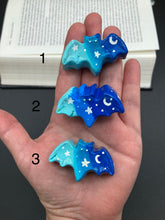 Load image into Gallery viewer, Cute and spooky magnet design to adorn your refrigerator, lockers, workstation, toolbox, or dishwasher. This hand-sculpted clay bat statuette boasts stunning ombre coloration, transitioning from dark blue to light blue to recreate the breathtaking look of a starry night sky. H 1” x W 2” x D 1/2”