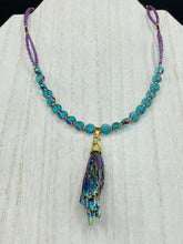 Load image into Gallery viewer, This necklace boasts a stunning Rainbow Kyanite wired stone pendant and two strands of shimmering glass beads. The blues contain hues of pink, gold, blue and green, offering a vibrant and bold addition to any jewelry collection. Measurements: Necklace is 17” in length, can be adjusted to 18"
