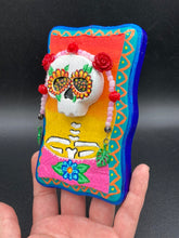 Load image into Gallery viewer, Transform your walls with this handcrafted polymer clay wall art. Showcasing a vibrant Frida Kahlo inspired calavera with hand-beaded floral crown, this Day of the Dead wall decor piece is perfect for adding a traditional Mexican folk art touch to any home.