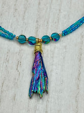 Load image into Gallery viewer, This Rainbow Kyanite Natural Wired Stone Choker Style Necklace presents two strands of light blue glass beads, and is adorned with a Kyanite stone known for its shimmering array of pink, gold, blue, and green hues. Providing a bold and attention-grabbing look, this piece of Hippie Crystal Jewelry is a must-have addition to any wardrobe. Necklace is 17 1/2” in length