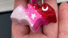 Load image into Gallery viewer, Cute and spooky magnet design to adorn your refrigerator, lockers, workstation, toolbox, or dishwasher. This hand-sculpted clay bat statuette boasts stunning ombre coloration, transitioning from dark red to light pink to recreate the breathtaking look of a starry night sky. H 1” x W 2” x D 1/2”