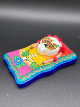 Load image into Gallery viewer, Transform your walls with this handcrafted polymer clay wall art. Showcasing a vibrant Frida Kahlo inspired calavera with hand-beaded floral crown, this Day of the Dead wall decor piece is perfect for adding a traditional Mexican folk art touch to any home.