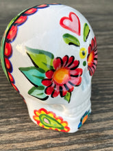Load image into Gallery viewer, Inspired by nature, ceramic skull is full of vibrant colors and intricate details. The primary color is white with a black cat silhouette and multi-color floral motifs, along with hearts and leaves and lively colorful accents around the entire skull. Mini skull represented the eternal love for a special kitty cat in your life. Black cat silhouette is sitting on a tree branch admiring the starry night sky. Art created for all the cat lovers who adore their sweet kitty. Measurements: H 2 3/4” x W 2” x D 2”