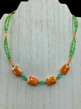 Load image into Gallery viewer, This unique, double-strand necklace consists of a blend of glass beads, including multi-green and rectangular, faceted orange glass beads, and is accented with gold and light blue elements. The vibrant combination is perfect for any summer look and will enhance any outfit.  Measurements:  Necklace is 16” and can be adjusted up to 18"
