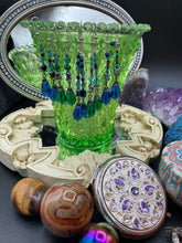 Load image into Gallery viewer, This stunning, one of a kind pair of celestial beaded earrings is a bold addition to any jewelry collection. Crafted with vibrant blue glass beads, the color contains varied shades of blue, purple, and hints of gold to create unique texture. The design is inspired by the awe-inspiring beauty of the majestic galaxy. Measurements: 2” in length