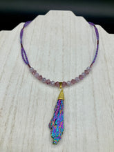 Load image into Gallery viewer, This Rainbow Kyanite Wired Stone Pendant features two strands of glass bead necklaces with a dazzling spectrum of colors, including purple, pink, gold, blue, and green. This bold piece of jewelry is guaranteed to add an eye-catching touch to any collection. Measurements: Necklace is 17” in length, can be adjusted to 18"