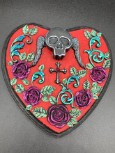 Load image into Gallery viewer, This Memento Mori Wall Art Decor is a one-of-a-kind art piece, skillfully crafted with a black polymer clay skull and wings on a dark red wood frame, decoratively woven with dark red roses and vines. It's perfect for adding an eye-catching touch to any wall and makes a unique, bold gift. Measurements: H 6 3/4" x W 7” x D 1 1/2"