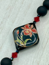 Load image into Gallery viewer, This statement necklace features elegant black matte glass beads with a smooth and velvety finish. Four ornamental ceramic beads with a traditional red, golden, and green pattern create a classic aura and luster-speckled dark red beads bring a striking final touch to the singular look.  This necklace is simple and elegant piece, very versatile look. Perfect cocktail chic attire, fancy wedding necklace, a minimalist look. Necklace: 32” in length