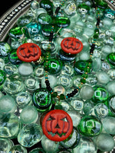 Load image into Gallery viewer, This 25mm bright orange pumpkin bead pendant necklace is a perfect complement to any Halloween ensemble. It is additionally enhanced by shimmery glass beads in classic Halloween hues, such as black, dark green, and light green. Measurements: Necklace is 19”