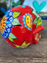 Load image into Gallery viewer, This uniquely handpainted ceramic skull is inspired by the beauty of Sedona, AZ. Features bold fire red color with nature-inspired design for a truly one-of-a-kind mini calavera. Perfect for adding a southwestern touch to your Dia de Los Muertos ofrenda. Measurements: H 4” x W 4” x D 5 1/2”