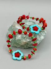 Load image into Gallery viewer, These bamboo coral red stone chip earrings feature tiny turquoise, green, and gold glass beading. Accenting the vibrant design is a turquoise flower pendant with quartzite rose beads for added detail. Measurements: 2 1/4" length