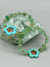 Load image into Gallery viewer, Achieve a simple nature look with these aventurine natural stone chip beaded hoop earrings. The green and gold glass beads and turquoise flower pendant with amber-tone glass beads add a bohemian-chic touch to any ensemble. These earrings are perfect for any free-spirited occasion. Measurements: 2 1/4" length