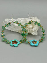 Load image into Gallery viewer, Achieve a simple nature look with these aventurine natural stone chip beaded hoop earrings. The green and gold glass beads and turquoise flower pendant with amber-tone glass beads add a bohemian-chic touch to any ensemble. These earrings are perfect for any free-spirited occasion. Measurements: 2 1/4" length