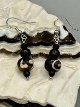 Load image into Gallery viewer, Mismatched round bone beads create an adaptable look when paired with neutral colors and wavy patterns, enabling wearers to tailor their ensembles in whatever way they desire. Measurements: 1 1/2 ” in length