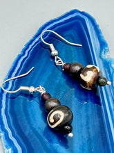 Load image into Gallery viewer, Mismatched round bone beads create an adaptable look when paired with neutral colors and wavy patterns, enabling wearers to tailor their ensembles in whatever way they desire. Measurements: 1 1/2 ” in length