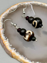 Load image into Gallery viewer, Mismatched round bone beads create an adaptable look when paired with neutral colors and wavy patterns, enabling wearers to tailor their ensembles in whatever way they desire. Measurements: 1 1/2 ” in length