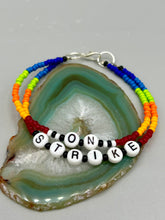 Load image into Gallery viewer, Rainbow Pride beaded bracelet ON STRIKE Metal wire with hook-eye clasp.