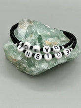 Load image into Gallery viewer, This set of Sarcastic Beaded Bracelets features fun and fashionable accessories perfect for any occasion. Crafted from metal wire and equipped with a hook-eye clasp, these sassy, sarcastic bracelets come in black and white and rainbow style. They are sure to make a statement. A fun addition to any accessory collection. Measurements: Black and White Color "Dead Inside": 8 1/4" in length Rainbow Color "U Suck": 8 1/2” in length