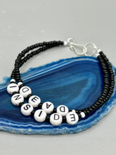 Load image into Gallery viewer, This set of Sarcastic Beaded Bracelets features fun and fashionable accessories perfect for any occasion. Crafted from metal wire and equipped with a hook-eye clasp, these sassy, sarcastic bracelets come in black and white and rainbow style. They are sure to make a statement. A fun addition to any accessory collection. Measurements: Black and White Color "Dead Inside": 8 1/4" in length Rainbow Color "U Suck": 8 1/2” in length