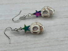 Load image into Gallery viewer, Howlite Skull Beads Earrings With Large Star Shapes Rainbow Hematite Bead. Versatile style, pastel goth, celestial stardust, witchy, day of the dead. You can dress these up or down, it will definitely give your outfit a unique look. Measurements: 1 ” in length