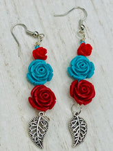 Load image into Gallery viewer, Alluring and enchanting southwest inspired dainty set of earrings captures the beauty of the desert full of blue turquoise and bright red colors, highly detailed and vibrant quartize rose beads and intricate silver plated leaf gives a fun movement. Perfect for you southwest nature lovers, Dia De Los Muertos, . You can dress these up or down, it will definitely give your outfit a unique look. Measurements: 2 1/2” in length