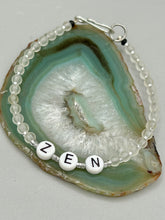 Load image into Gallery viewer, Hand beaded bracelet with clear and silver glass beads, Zen letters Metal wire with hook-eye clasp.